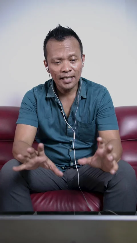 Asian man freelancer talking at web virtual meeting on laptop camera. Stock Footage 281425322