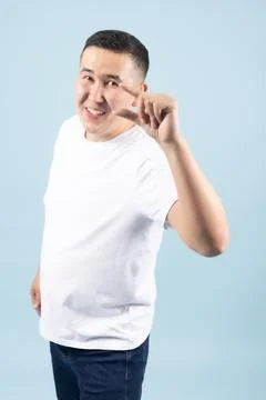 Asian Man Gesturing Small Size with Fingers Stock Photos