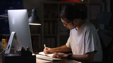 Asian man graphic designer working on computer drawing sketches logo design. Видео 248529392
