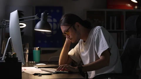 Asian man graphic designer working on computer drawing sketches logo design. Видео 248529838