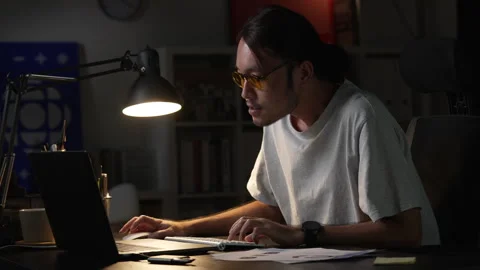 Asian man graphic designer working on computer drawing sketches logo design. 库存影片 248530169
