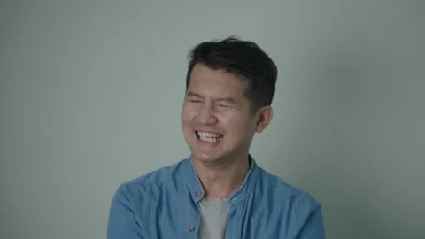 Asian man happy laughing standing on white background. Stock Footage 241582753