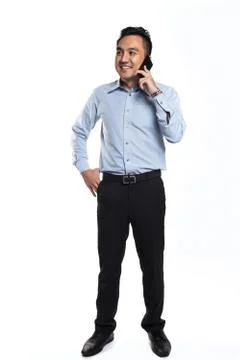 Asian man happy while talking over the phone Stock Photos