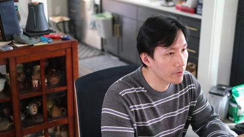 Asian man having a conversation with camera off centered Stock-Footage 318189493