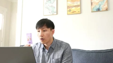 Asian man having an online class with students about soda Stock Footage 247480036