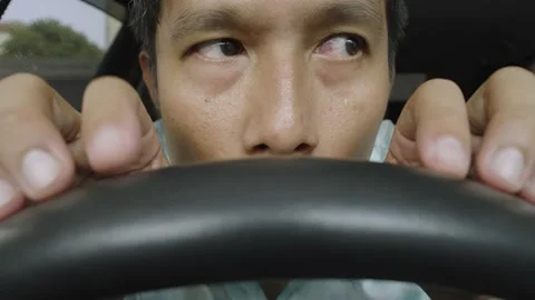 Asian man having problem, hiding or waiting someone in the car. Stock Footage 236843400