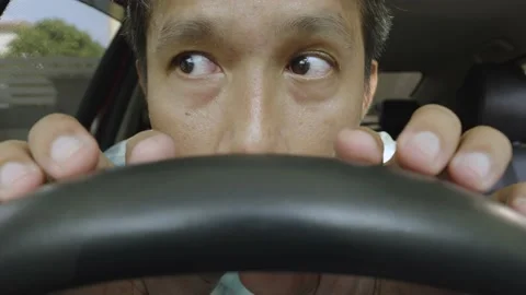 Asian man having problem, hiding or waiting someone in the car. Stock Footage 236843457