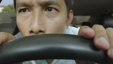 Asian man having problem, hiding or waiting someone in the car. Stock Footage 236843463