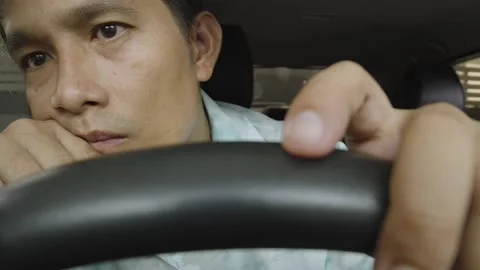 Asian man having problem, waiting someone in the car. Stock Footage 236930090