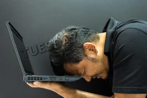 Asian man hold computer notebook in stress gesture Foto stock