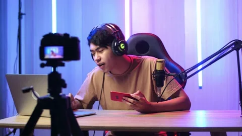 Asian Man Holding Read Comment In Laptop Computer Then Talking While Live Stream Video stock 173623746