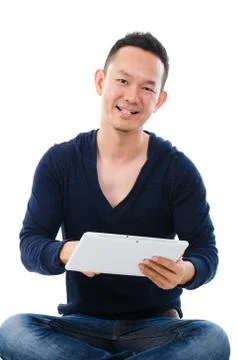 Asian man holding tablet computer isolated on white background. Stock Photos