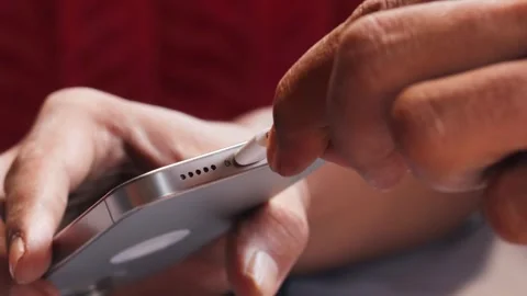 Asian man inserting a USB-C connector into a modern smartphone Stock-Footage 347114466