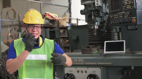 Asian man inspector, engineer serious angry ordered work through radio commun Stock Footage 125230736