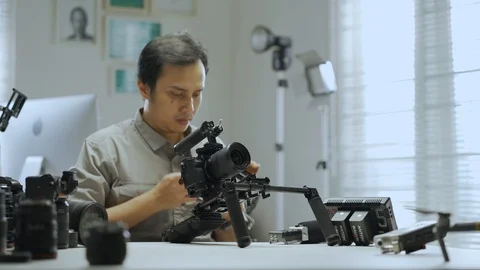 An Asian man is installing a camera rig  Stock Footage 128407164