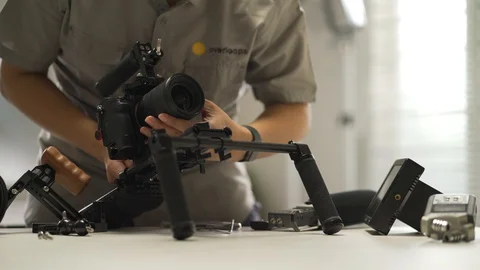An Asian man is installing a camera rig and fastening it Video stock 128407165