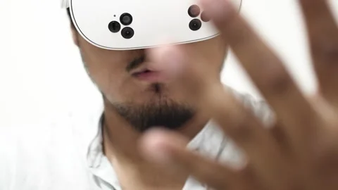Asian man interacting with virtual reality headset Stock Footage 309772487