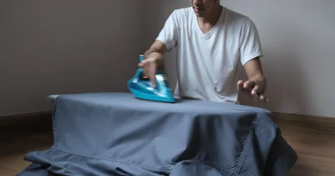 Asian man ironing iron with steam Stock-Footage 141363553