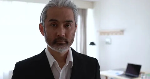 Asian man looking on camera inside modern office Stock Footage 172538017