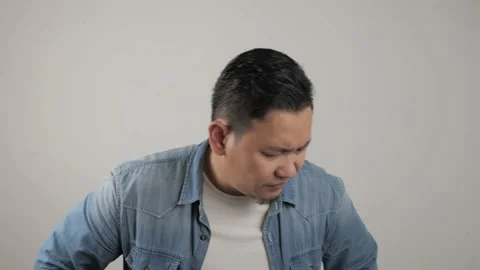 Asian man looking at camera with sad and regret expression, disappointed  Stock Footage 143772788