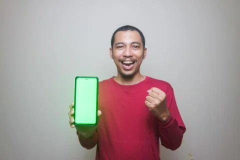 Asian man looking to camera, smiling and showing empty blank white copy spa.. Stock Photos