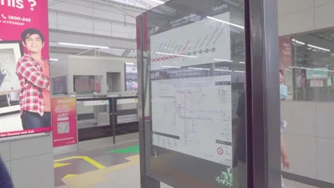 An asian man is looking for his destination station in jakarta mrt map Stock Footage 222033345
