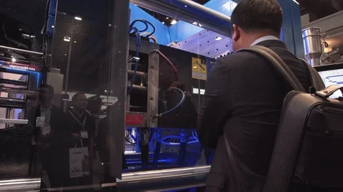 Asian Man Looking at Machine Manufacturing Plastic Item Stock Footage 126168996
