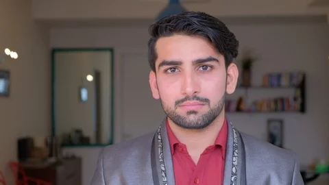 Asian man looks directly at the camera expressionless in a suit Stock Footage 101286406