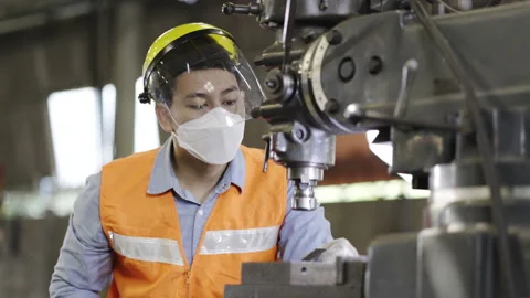 Asian man Machine engineer wearing face shield work in factory Industry. Stock Footage 154366536
