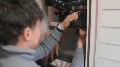 Asian man making ice cream cone with machine 4k Stock Footage 84875284