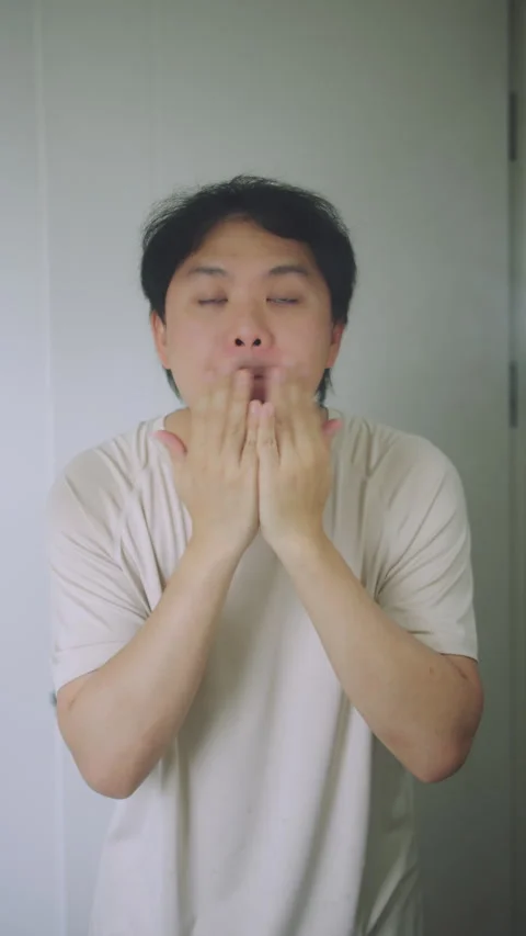 Asian Man Massaging His Face and Checking Skin in Bathroom Mirror, Men Skincare  Stock Footage 337769472