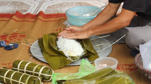 Asian man packing rice cake | Stock Video | Pond5