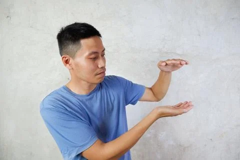 The Asian man pointed to the empty space beside him Stock Photos