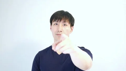 Asian man pointing to the camera with his left hand longer hold Stock Footage 248868919