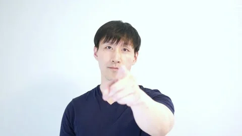 Asian man pointing to the camera with his left hand quickly Stock Footage 248868929