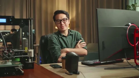 Asian Man Pose While Works On Personal Computer And 3D Printer In Home Office Stock Footage 158107863