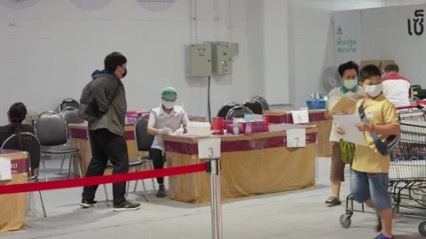 Asian Man Prepares to Get Covid Flu Vaccine Injection By Female Nurse Video stock 256094541
