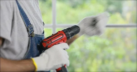 Asian man preparing electric drill . Stock Footage 98965419