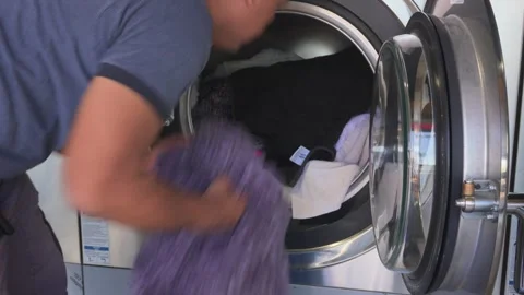 Asian Man putting clothes inside the washing machine Video stock 310228646