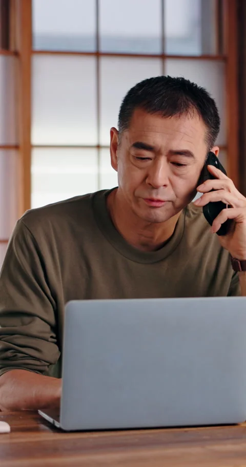 Asian man, remote work or laptop in home with phone call, article update or Stock Footage 340976930