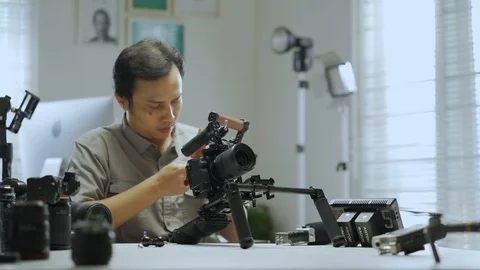 An Asian man is removing a series of camera rigs Video stock 128406661