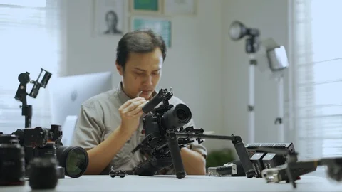 An Asian man is removing a series of camera rigs Video stock 128406671