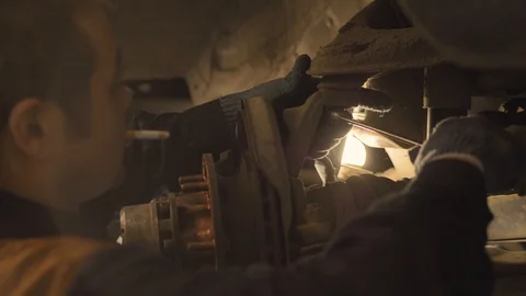 Asian man repairs an old car in a car workshop, close-up. Video stock 129823402