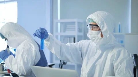 Asian man scientist with test blue tube making research in clinical laboratory Stock Footage 149043512