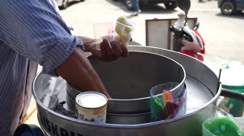 An Asian Man Scooping Ice Cream Under Hot Sunny Day In Market Stock Footage 34632766