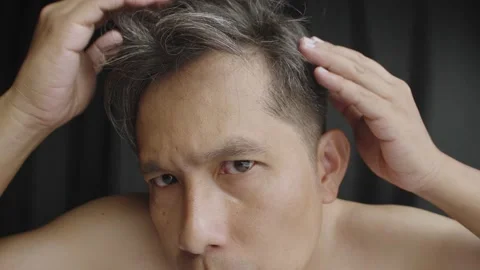 Asian man scratching his head with hoary hair. Stock Footage 235002136