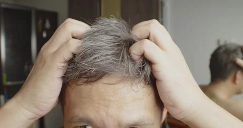 Asian man scratching his head with hoary hair problem. Stock Footage 246747665