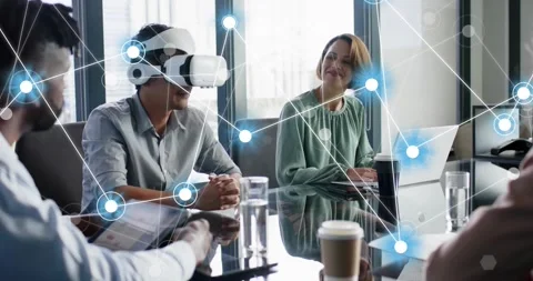 Asian man securing VR headset and showing network node graphics linking team in Stock-Footage 318607746