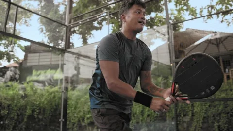 Asian man serving ball close up. Guy play racket padel tennis Asia. Male player. Stock Footage 237519228