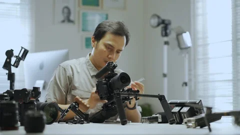 An Asian man is setting up a camera rig  Video stock 128406704